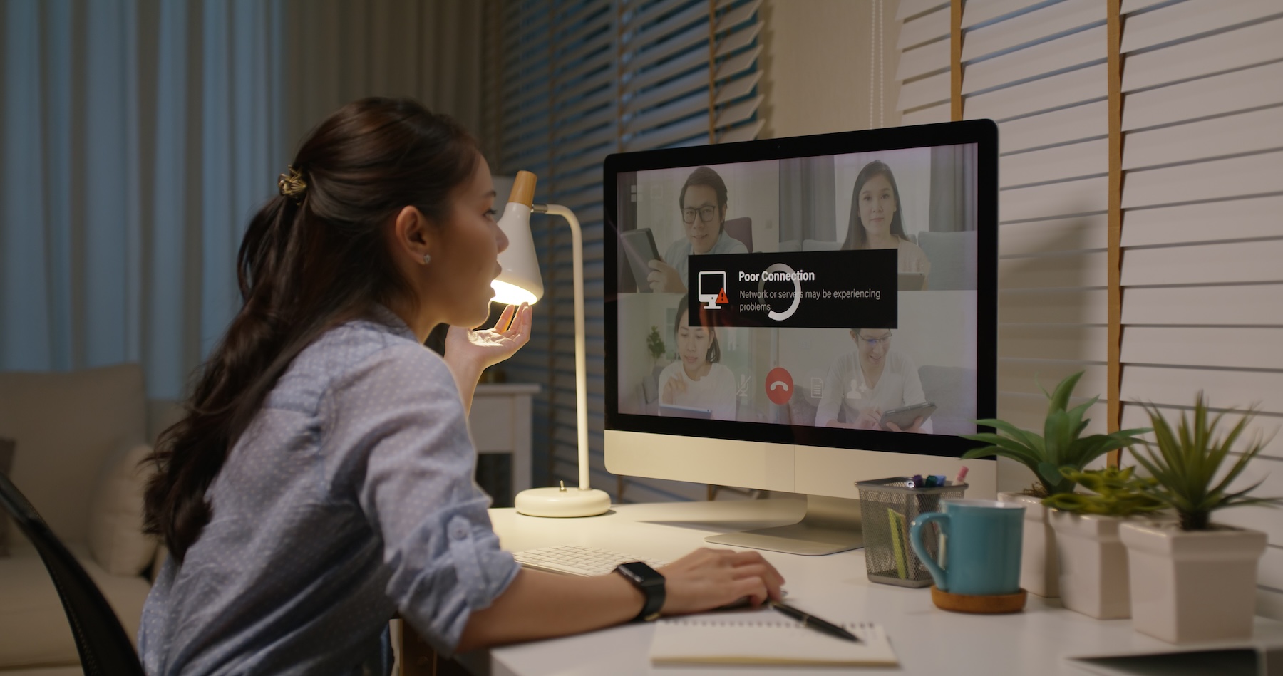 Woman frustrated with buffering home WiFi during business conference call