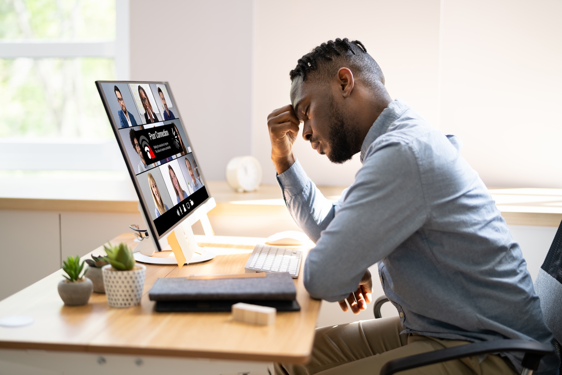 Remote worker frustrated with slow home Internet during a video call